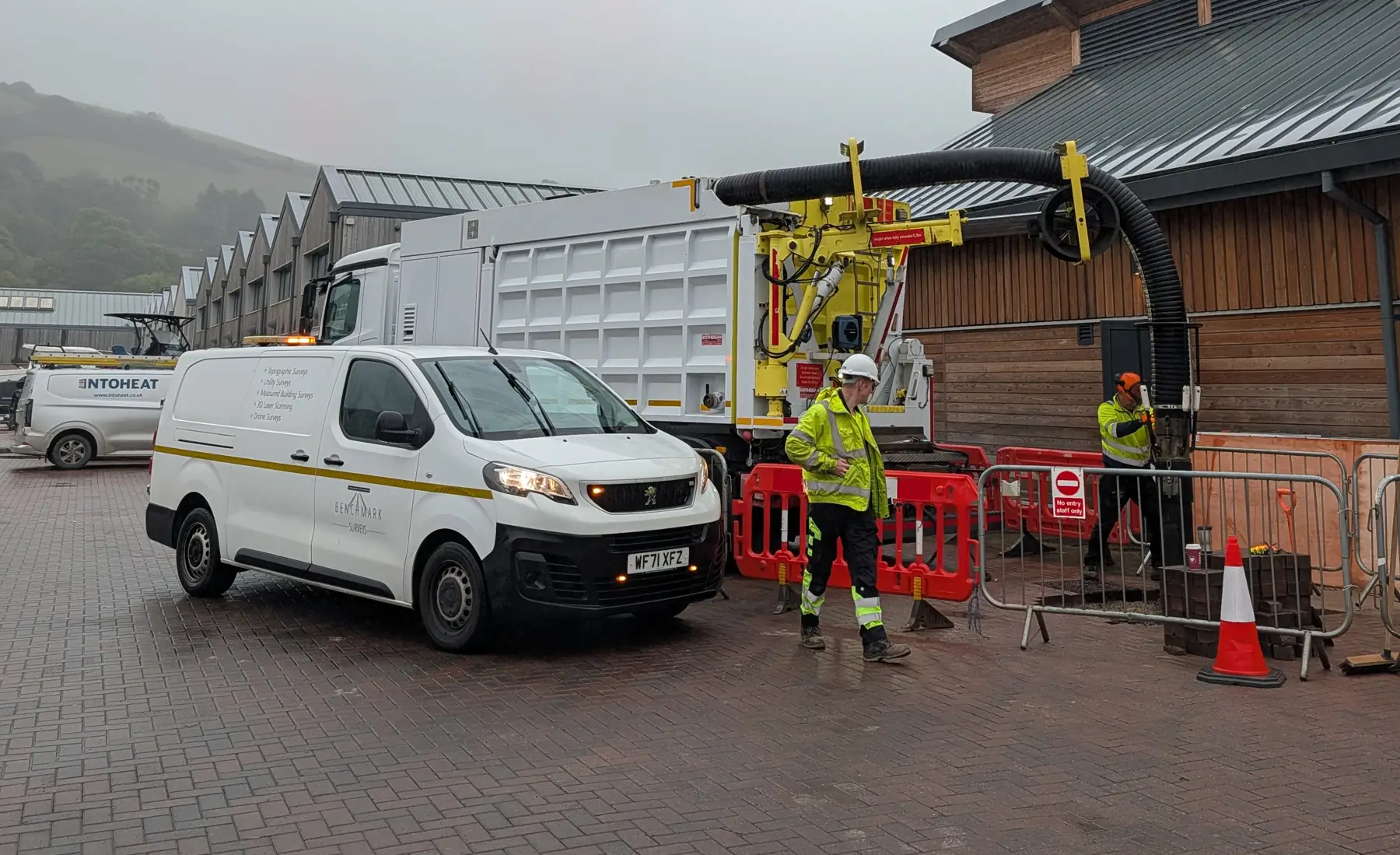 Vac Ease vacuum excavator working beside the Benchmark Surveys survey van on a quayside site