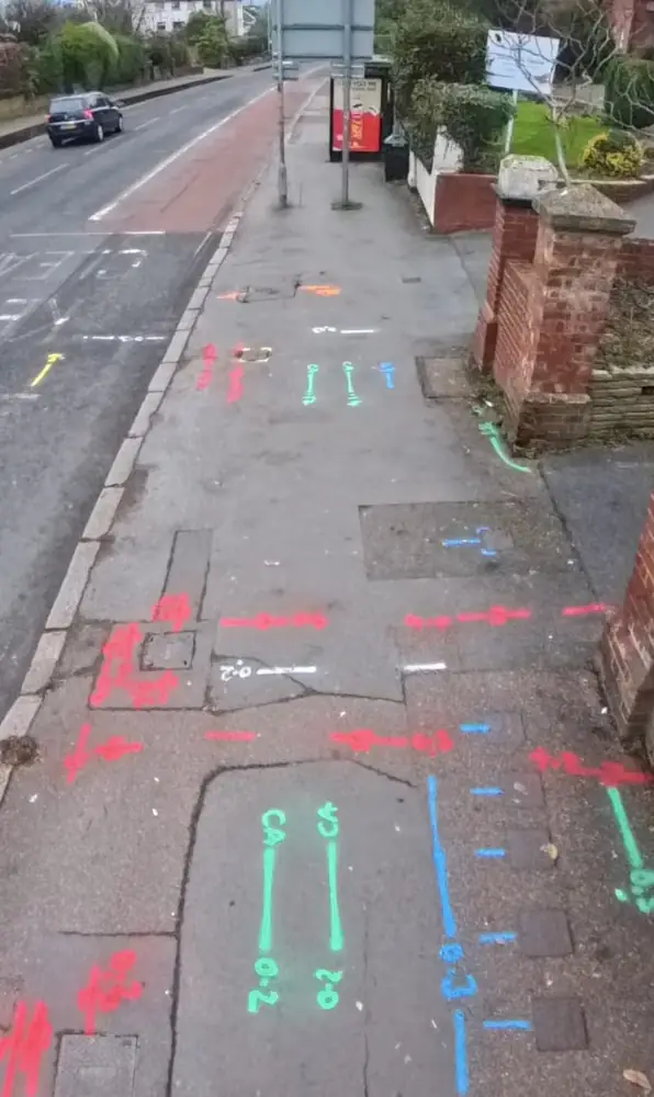 Footway marked with colour-coded services and depths